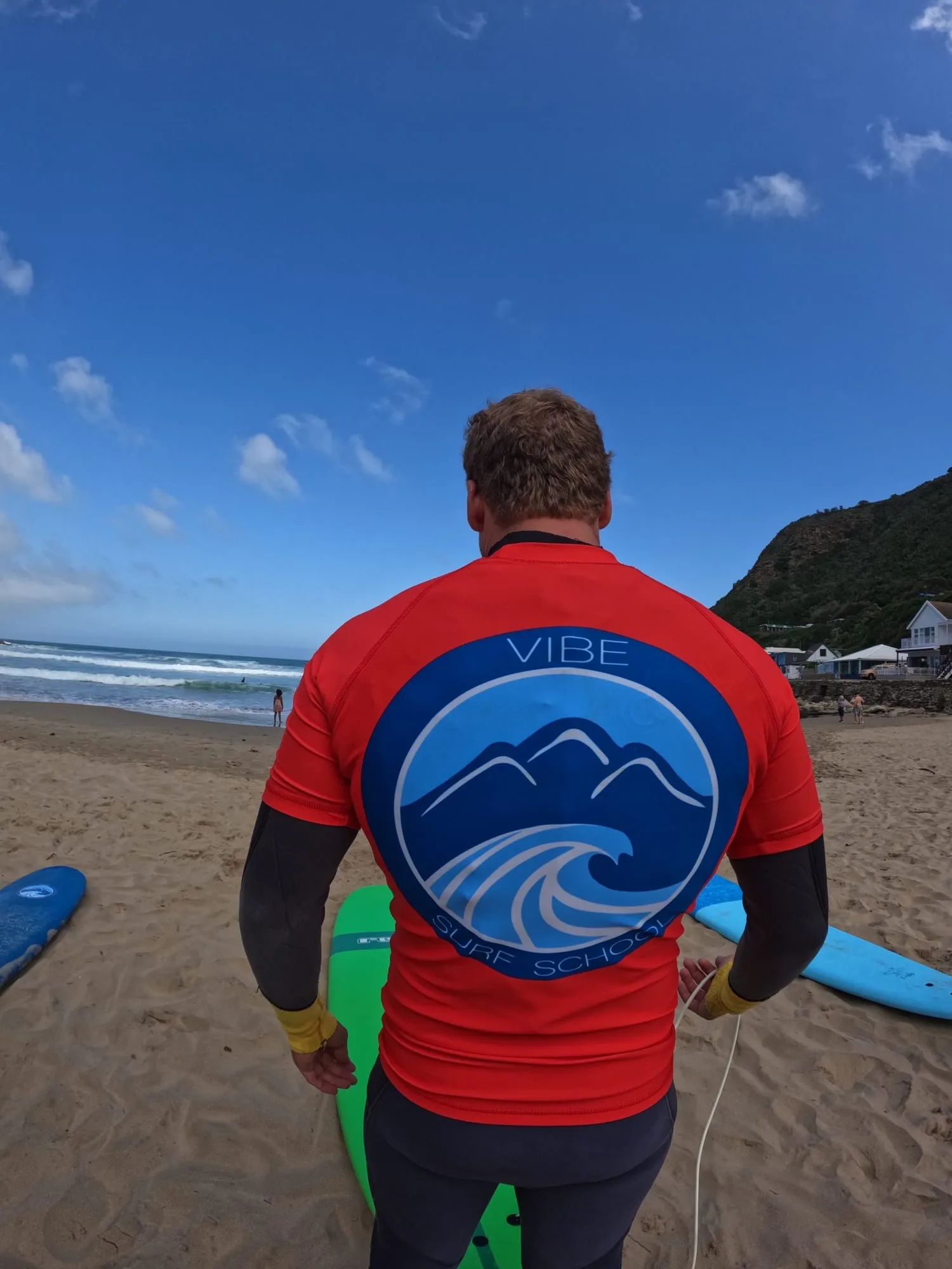 A Vibe Surf School instructor watching students in the water