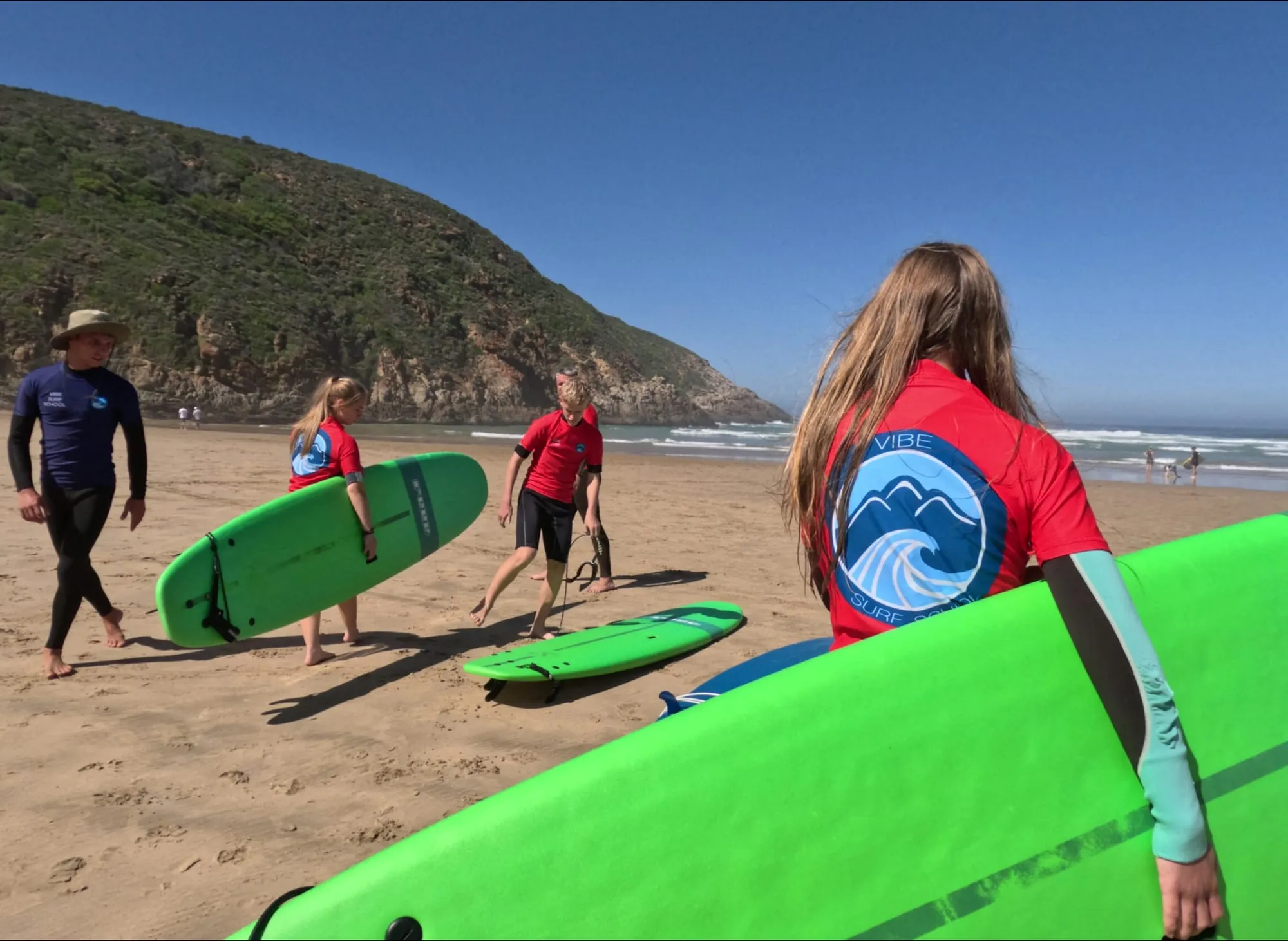 Instructor and students on the beach